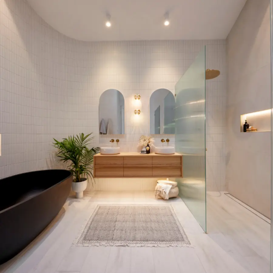Modern bathroom with natural wood vanity, two round mirrors, and recessed lights illuminating the shower area.