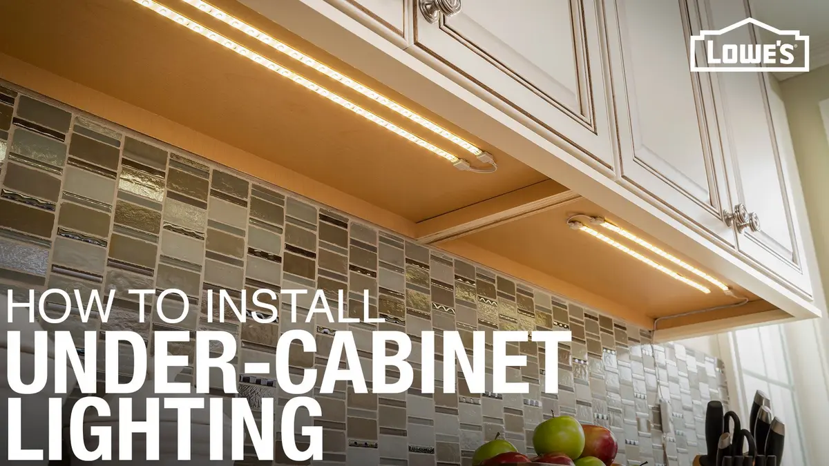 Under-cabinet lights illuminating a kitchen backsplash with cabinets above.