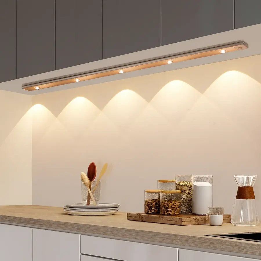 Under-cabinet lighting featuring a sleek design with multiple warm lights illuminating a kitchen countertop.